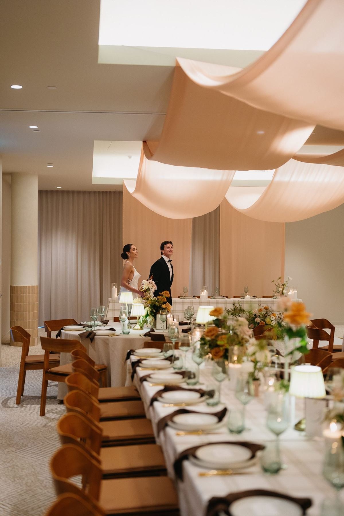 The couple at the head of a long table in the Ballroom