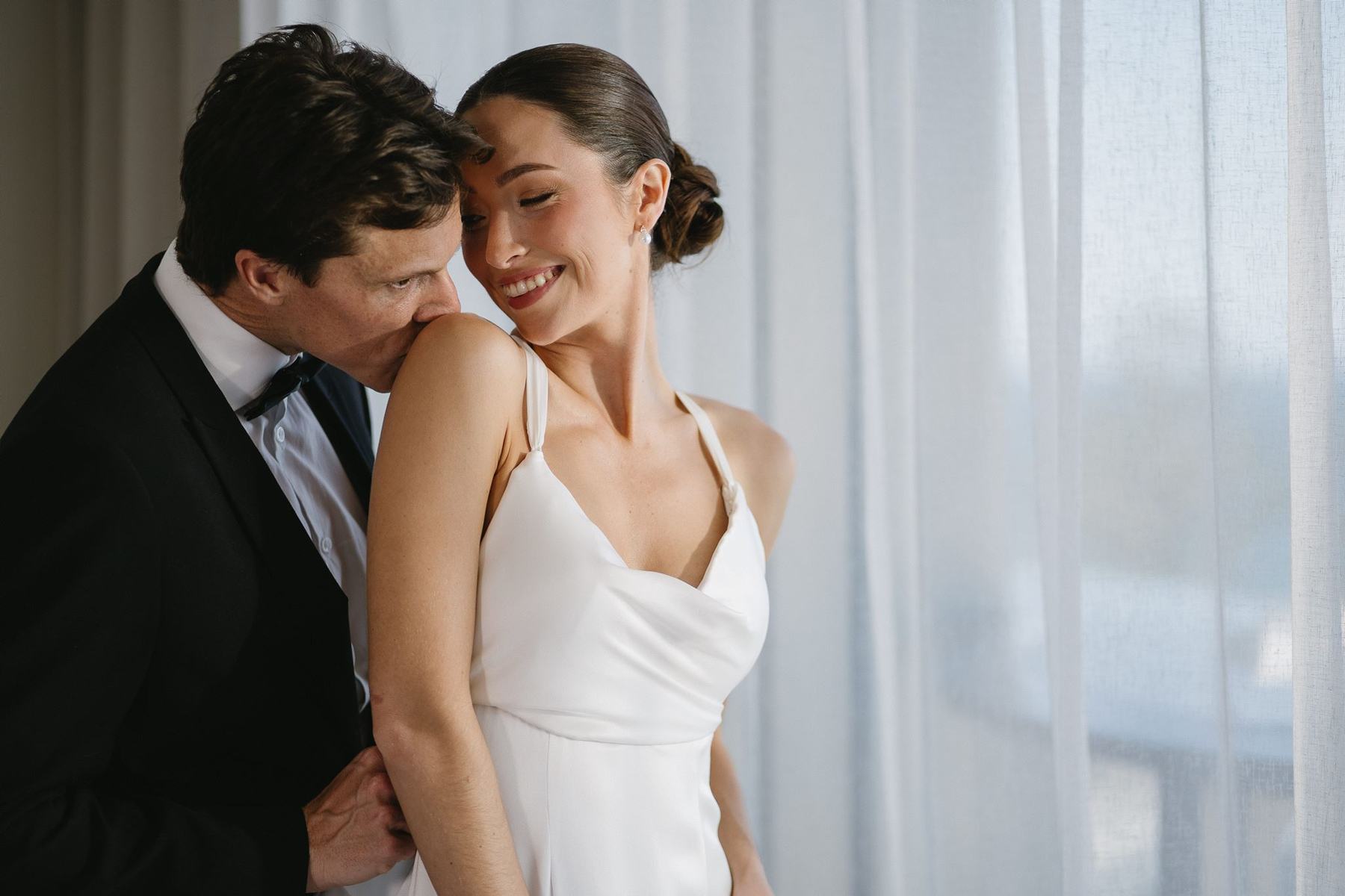 A couple laughing together in a suite